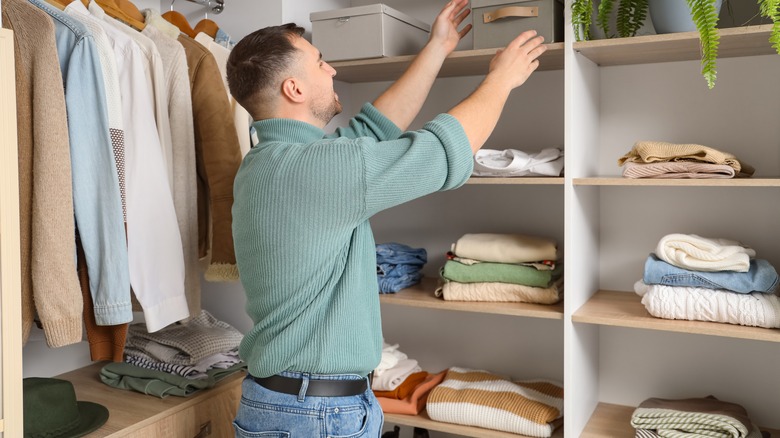 Someone organizing closet