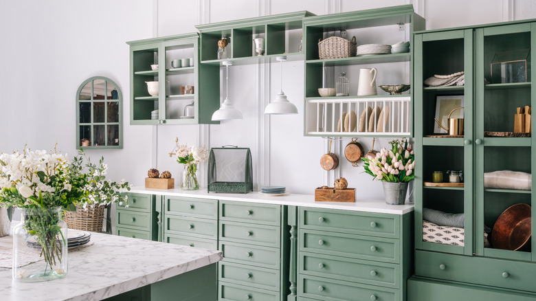 Airy kitchen with green cabinetry