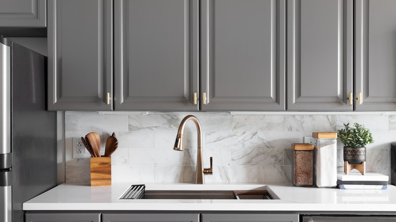 Kitchen sink and grey shaker cabinets