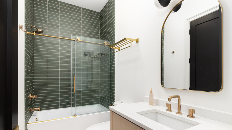 Shower with green subway tiles