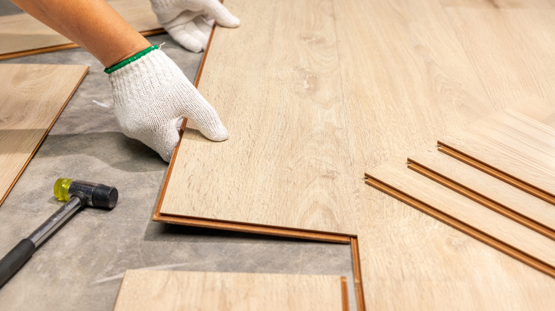 Person installing a laminate floating floor