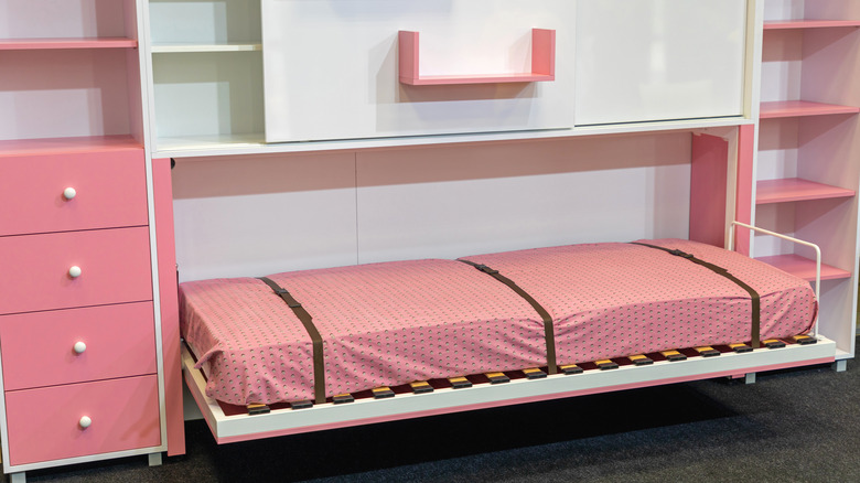 pink murphy bed with built in storage