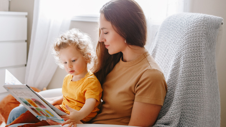 woman reading to a baby