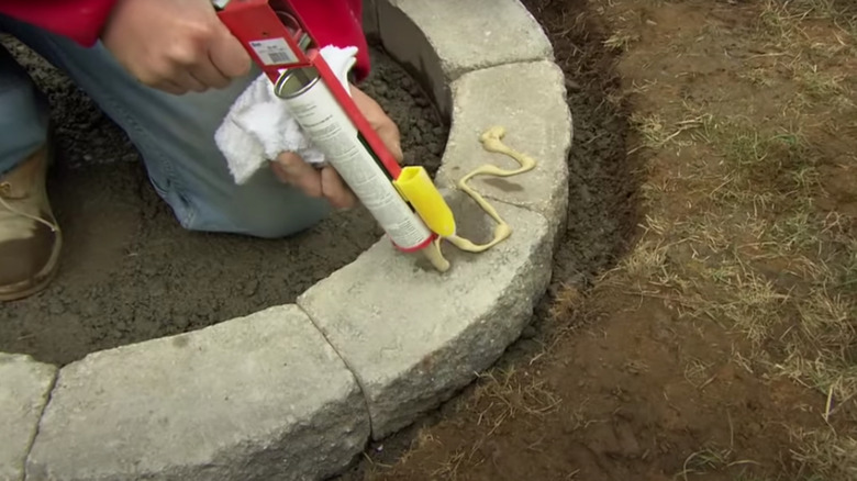 Person using concrete adhesive