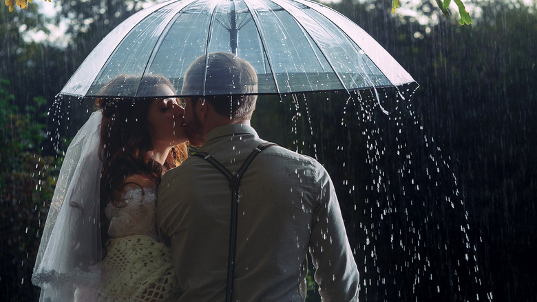 married couple under umbrella 