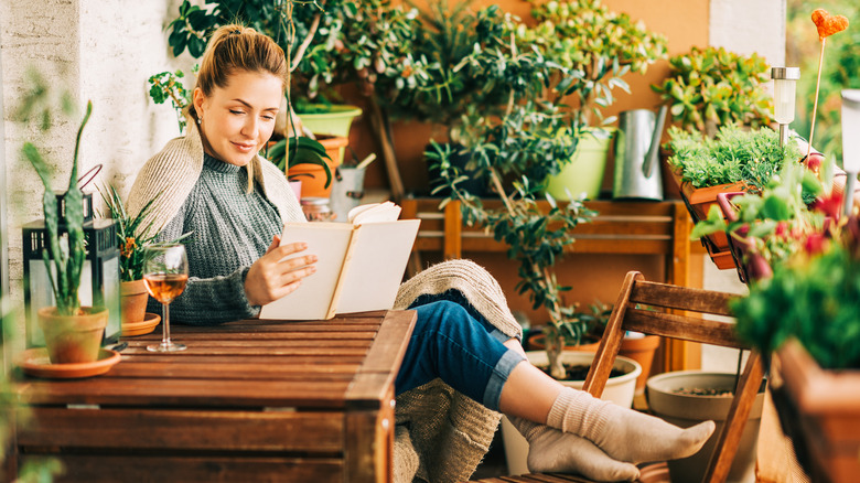 Woman relaxes in patio garden