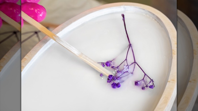 Person placing flower in resin