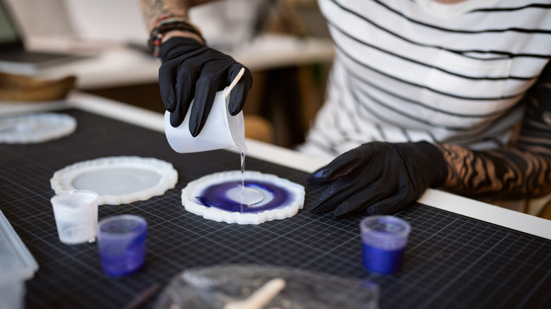 Person pouring resin into mold