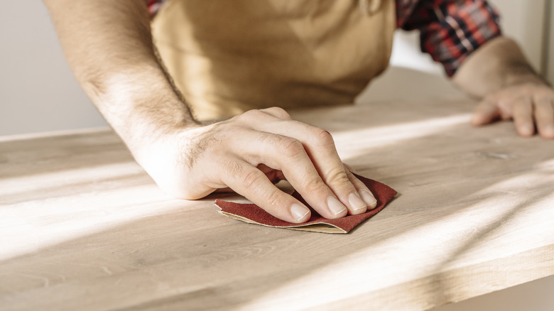 Person sanding wood