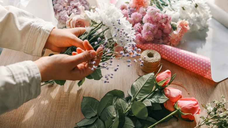 Hands assembling flowers