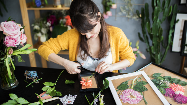 Woman cutting flower stem