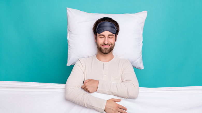 man in bed with pillow 