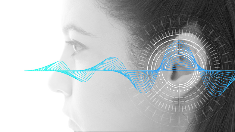 Side view of young woman with sound wave graphic