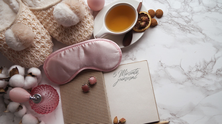 A journal sitting among comfort items