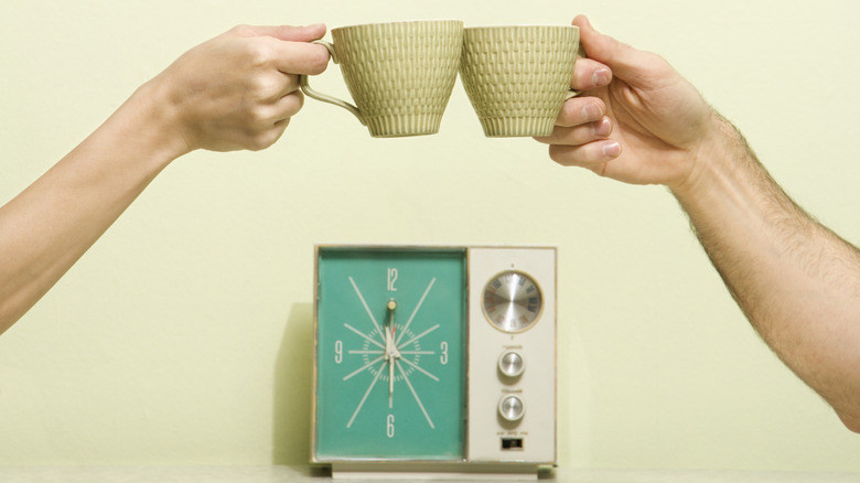 two hands toasting retro cups