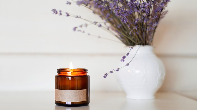 small candle and vase of lavender