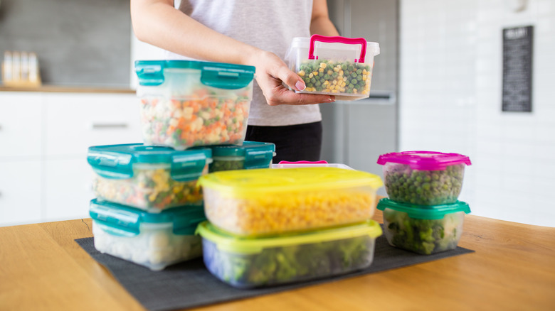 woman storing food in containers