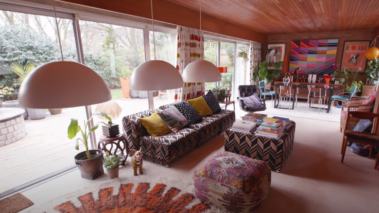 Colorful living room with mutliple round light shades and angular seating pieces