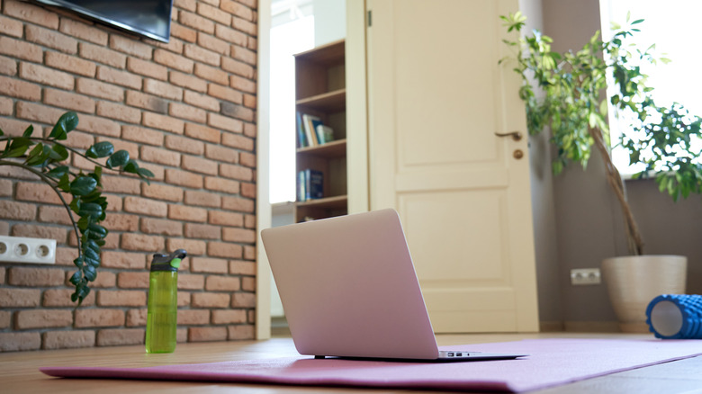 laptop on yoga mat in home