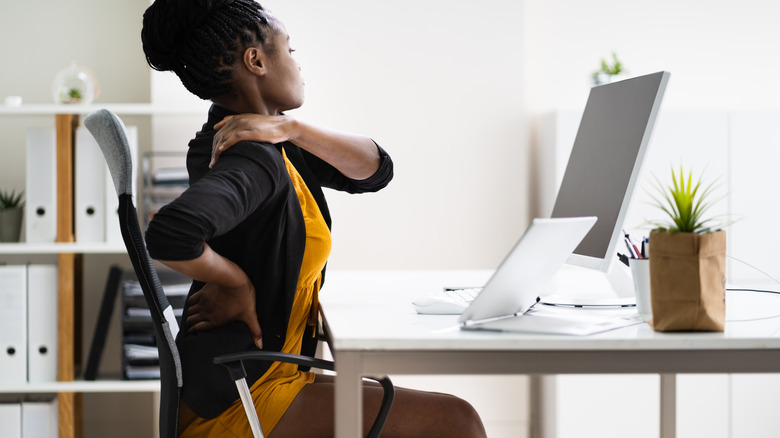 woman stretching at desk