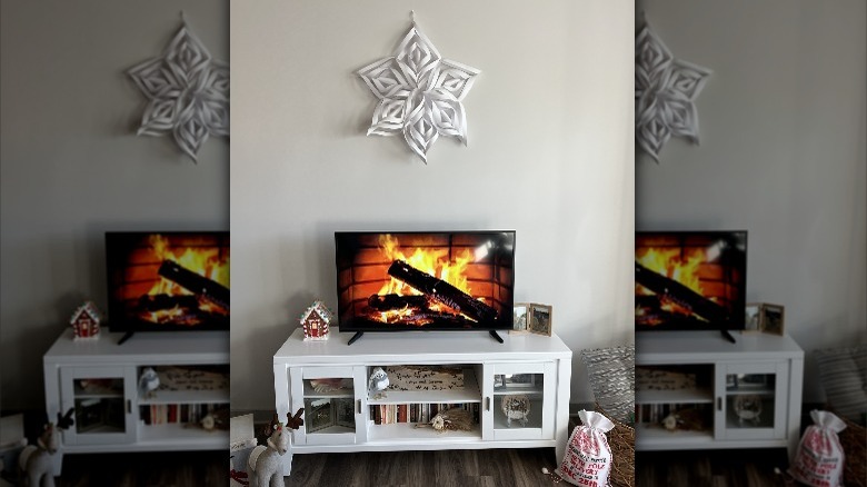 large paper snowflake above television