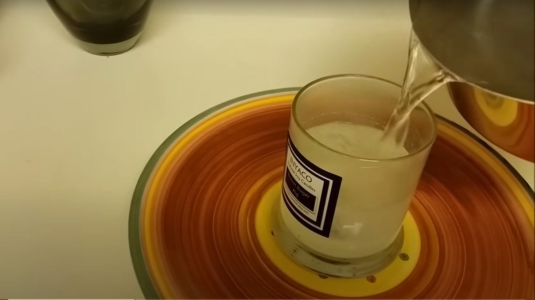 Pouring hot water in candle jar