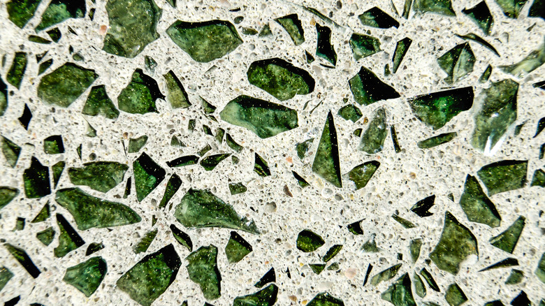 Green glass embedded in concrete