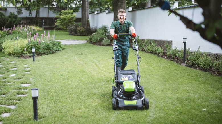 person mowing grass