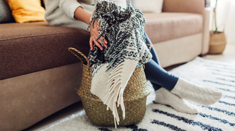 placing a blanket in basket