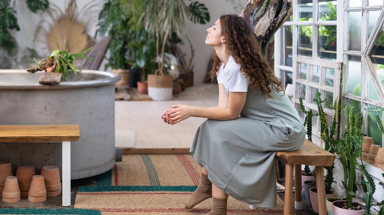 woman sitting in a greenhouse