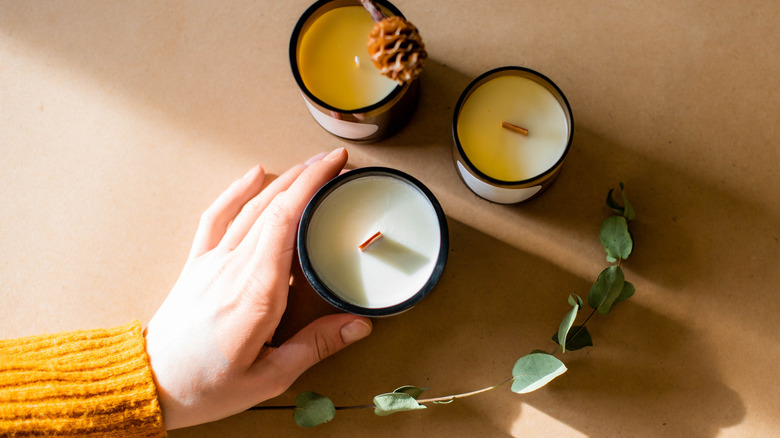 Woman's hand with three candles