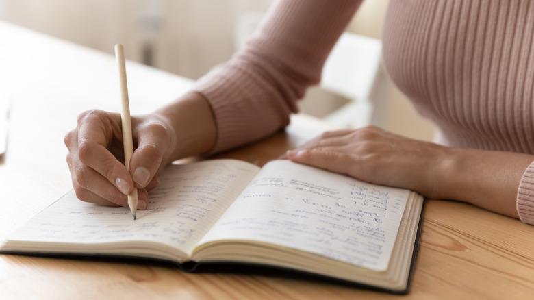 Woman writing in notebook