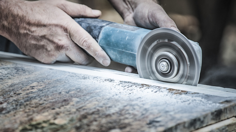 Person cutting granite