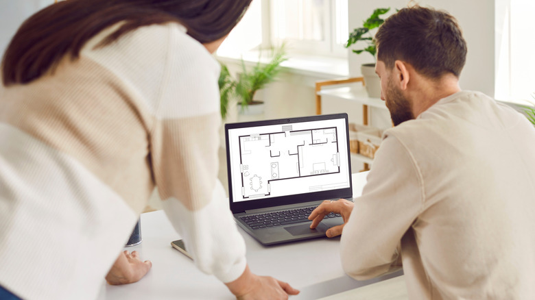 Couple looking at digital apartment floorplan