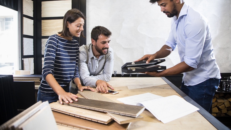 A couple looking at different flooring options