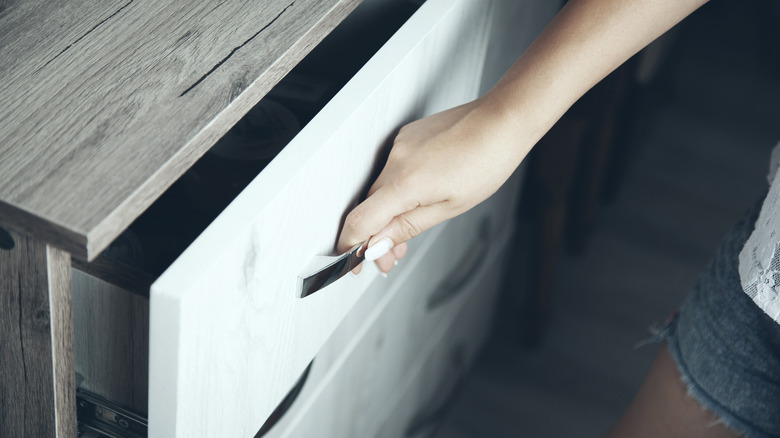 Hand opening a drawer