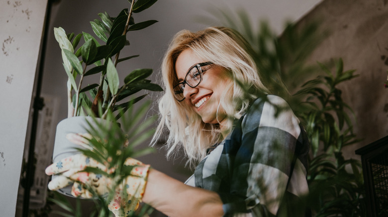 Woman setting plant in place