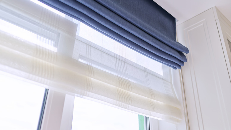 white and blue Roman blinds