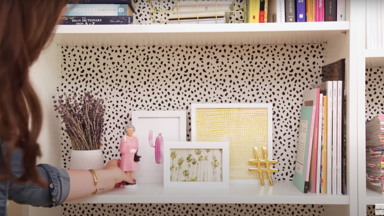 bookshelves with polka dot wallpaper