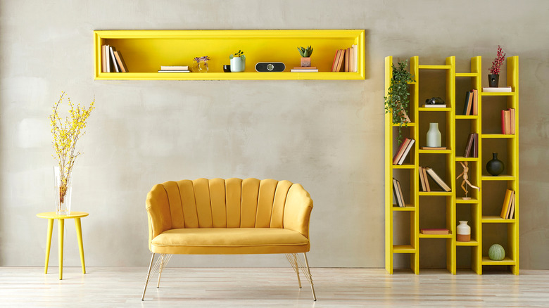 bright yellow bookshelf above couch