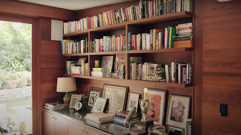 framed art on wooden bookshelf