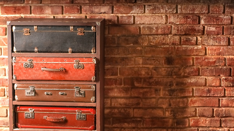 vintage suitcases by brick wall