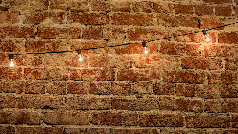 brick wall with string lights