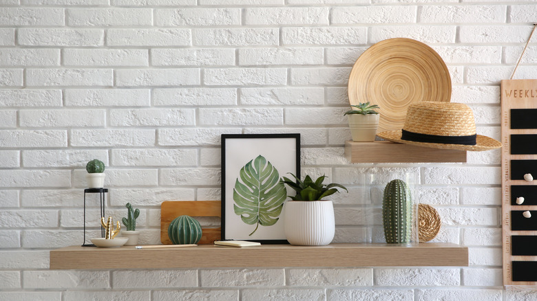 open shelving on brick wall