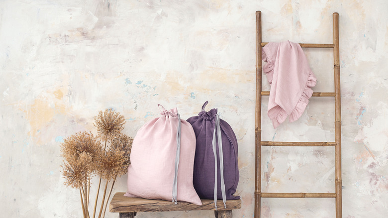 fabric laundry bags by ladder