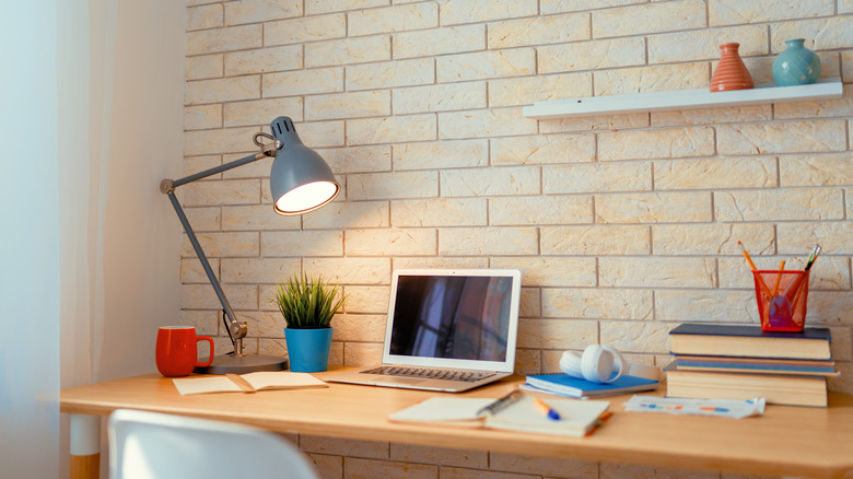 desk with laptop and lamp