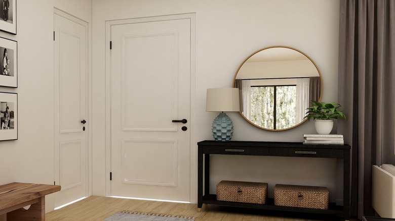 large round mirror over console