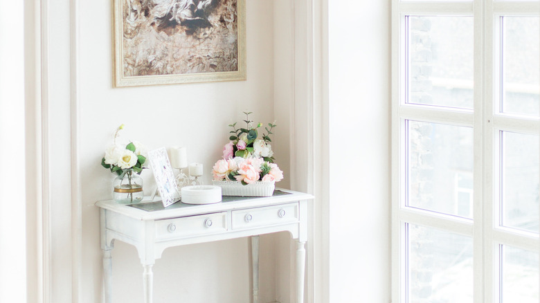 framed art over white console