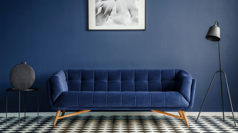 blue wall with velvet couch