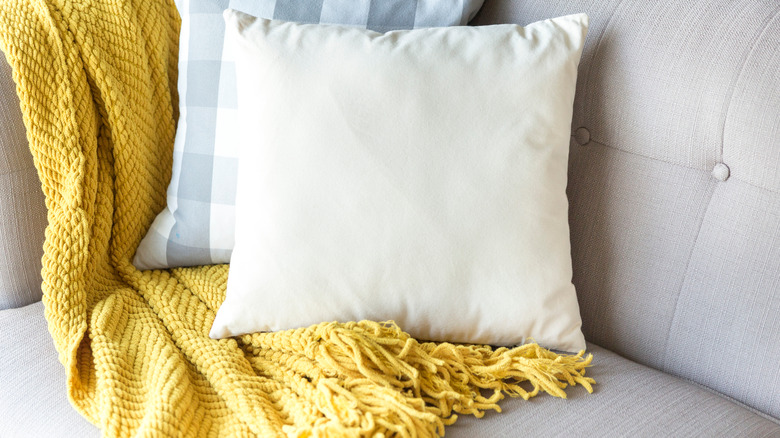 pillows with yellow blanket